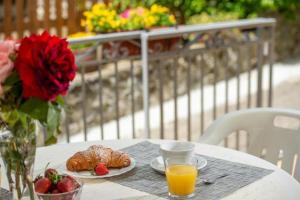 a table with a plate of croissants and a cup of orange juice at Casa Ersilia in Agerola