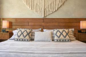 a bedroom with a large bed with two pillows at Modern Condo 200m from Beach & 5th Ave in Playa del Carmen +42 photos