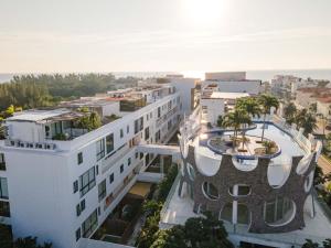an aerial view of a white building at Modern Condo 200m from Beach & 5th Ave in Playa del Carmen