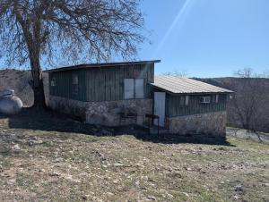 a small building with a tree in front of it at Cedarvale Cabins Turner Falls in Davis +22 photos