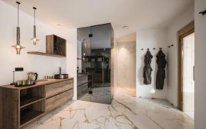 a bathroom with a walk in shower and a counter at Timeless Dolomites Apartments in Dobbiaco