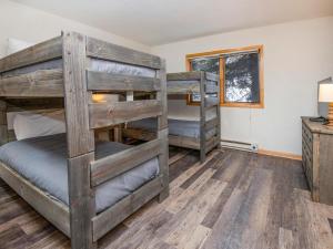 two bunk beds in a room with a desk at Greenbrier Townhouse #25 in Avon