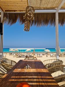 a table on the beach with a view of the beach at La Vista Luxorious Chalet North Coast Egypt in Ras Elhekma