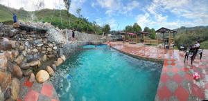 a water park with a swimming pool and a rock wall at Cabaña en Norcasia con Jacuzzi, piscina agua de manantial y opción de atracciones extremas Paraíso Xtreme in Confines +16 photos