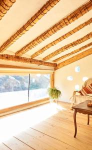 a living room with a table and a large window at Casa Rural La Encalá in Ayna +19 photos