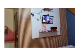 a television on a wall in a room at Golden Empress Hotel in Santa Barbara