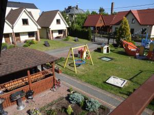 a toy yard with a playground in a house at Elizabeth Łeba - Pokoje Gościnne in Łeba