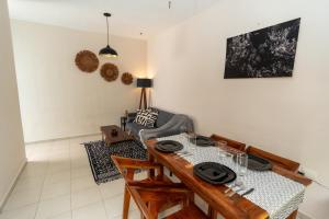 a dining room with a table and a couch at Colorful Downtown House with Private Pool in Tulum +30 photos