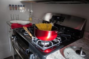 a pot on a stove with some pasta in it at Group Basecamp 6 Bedrooms Downtown GJ in Grand Junction