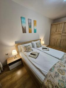 a bedroom with a large bed with two pillows at Апартамент Радост in Bansko