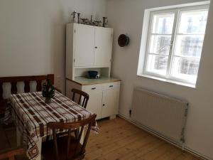 a kitchen with a table and a cabinet and a window at Kronichhof in Knappenberg