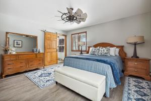 a bedroom with a bed and a chair and a mirror at Frogmore Cottage 17 in Glenn