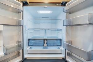 an empty refrigerator with its door open and its shelves at Perfect Group Stay 7 Beds Sleeps 15 Massage Chair 20 Min NYC in Bayonne
