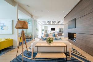 a living room with a couch and a table at Ivory at Aviara East Pompano in Pompano Beach
