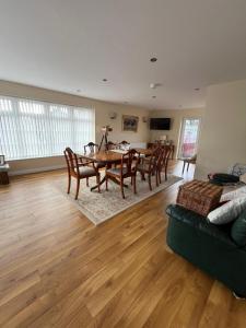 a living room with a table and chairs and a couch at Portora House Accommodation ROOM ONLY-ALL ROOMS EN-SUITE in Enniskillen