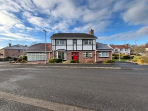 a house with a red door on a street at Portora House Accommodation ROOM ONLY-ALL ROOMS EN-SUITE in Enniskillen +17 photos