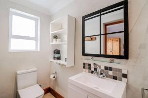 a bathroom with a sink and a mirror at 78 Beach Road - Seafront luxury bliss in Kleinmond