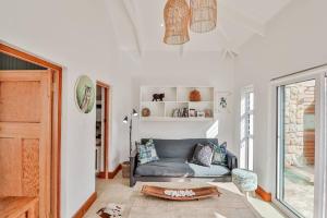 a living room with a couch and a table at 78 Beach Road - Seafront luxury bliss in Kleinmond