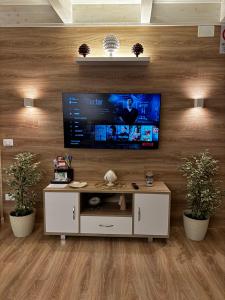 a living room with a flat screen tv on a wall at MOH - Il Maniero in Grottaglie