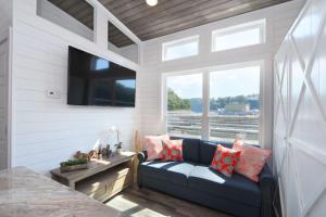 a living room with a blue couch and a window at TV Blue Tiny Houseboat at Lake Cumberland Marina in Nancy