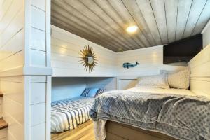 a bedroom with a bed in a room with a ceiling at TV Blue Tiny Houseboat at Lake Cumberland Marina in Nancy