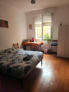 a bedroom with a bed and a table and a desk at Bed&Breakfast delle Lame in Bologna +6 photos