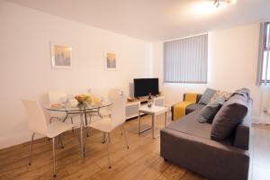 a living room with a couch and a dining room table at 2BR, smart TV, self check-in, coffee machine in Manchester