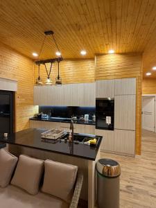 a kitchen with a counter and a couch in a room at Denver Villa in Sagmosavan