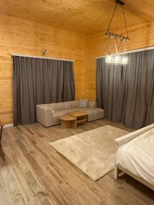 a living room with a couch and a table at Denver Villa in Sagmosavan