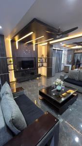 a living room with a couch and a table at Khaleel Manzil Luxe Stays in Hyderabad