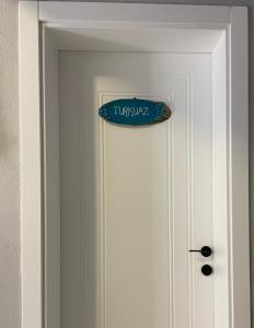 a sign on the door of a white door at Kyla Kocadere Mansion in Eceabat