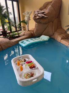 a pool with a table with food in the water at Maupa Mountain view in Krugersdorp