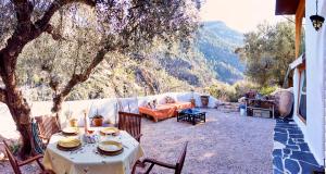 a table and chairs on a patio with a view at Casa Rural La Encalá in Ayna