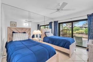 a bedroom with two beds and a window at First Floor Deluxe Condo -Updated and Chic in Naples