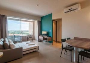 a living room with a couch and a table at SOLAR DAS AGUAS PARQUE RESORT in Olímpia +10 photos