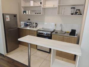 a small kitchen with a white counter in it at Departamento en Talca con 2 dormitorios in Talca