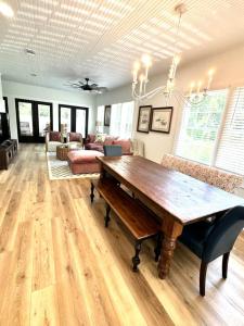 a living room with a wooden table and a couch at The Big Twisted Oaks in Bay Saint Louis