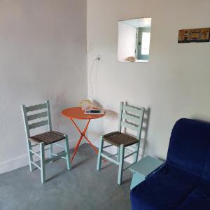 a room with a table and two chairs and a table at Secluded 200-Year-Old Cycladic Retreat in Milos in Adamantas +15 photos