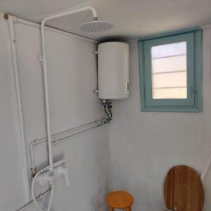 a bathroom with a window and a toilet at Secluded 200-Year-Old Cycladic Retreat in Milos in Adamantas