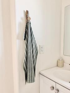 a towel hanging on a wall next to a sink at Desert Dream Cabin, Healing Mineral Water Tub in Twentynine Palms