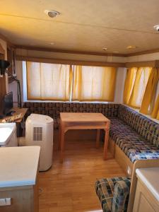 a living room with a couch and a table at Sítio da Cornucópia Home Mobile in Moncarapacho