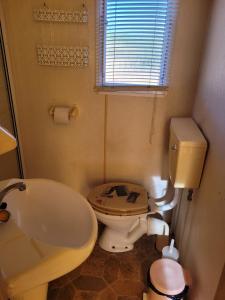 a bathroom with a toilet and a sink and a tub at Sítio da Cornucópia Home Mobile in Moncarapacho +28 photos