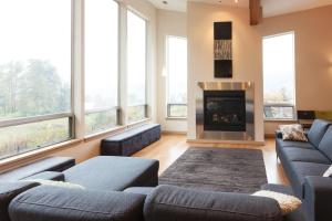 a living room with couches and a fireplace at Mountain House in Mount Hood