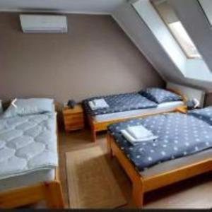 A bed or beds in a room at Fáraó vendégház