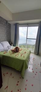 a bedroom with a bed with flowers on the floor at Rm Staycation TaalView Smdc in Tagaytay
