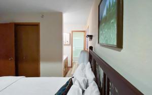 a bedroom with a bed with a tv on the wall at Cozy Ski-In Ski-Out Big Mountain Condo in Whitefish