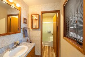 a bathroom with a sink and a mirror at Cozy Ski-In Ski-Out Big Mountain Condo in Whitefish