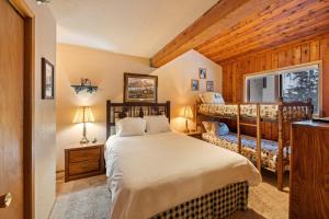 a bedroom with a bed and two bunk beds at Cozy Ski-In Ski-Out Big Mountain Condo in Whitefish