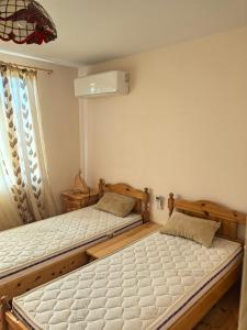 a bedroom with two twin beds and a fan at Вила Езерото in Lipnik +28 photos