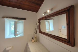 a bathroom with a large mirror and a tub at Refúgio da Alma in Mafra